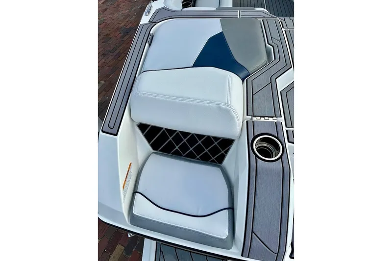 Slide: The Image of 2018 Nautique Super Air Nautique GS22 boat interior with sleek seating and cup holder. - 17