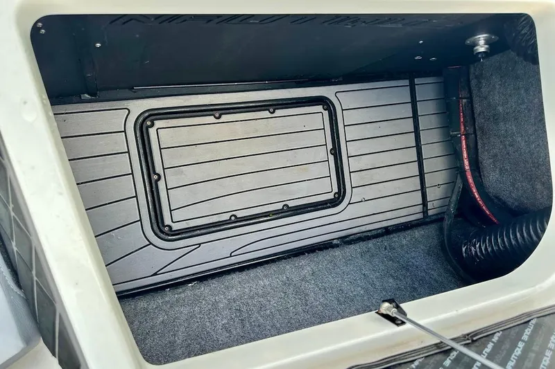 Slide: The Image of 2018 Nautique Super Air Nautique GS22 storage compartment interior view. - 19