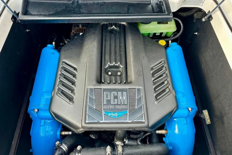 Slide: The Image of 2018 Nautique Super Air Nautique GS22 engine with PCM cover and blue components. - 20