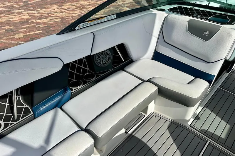 Slide: The Image of 2018 Nautique Super Air Nautique GS22 interior with gray seating and cup holders. - 28