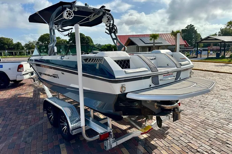 Slide: The Image of 2018 Nautique Super Air Nautique GS22 boat on trailer, parked on brick pavement. - 3