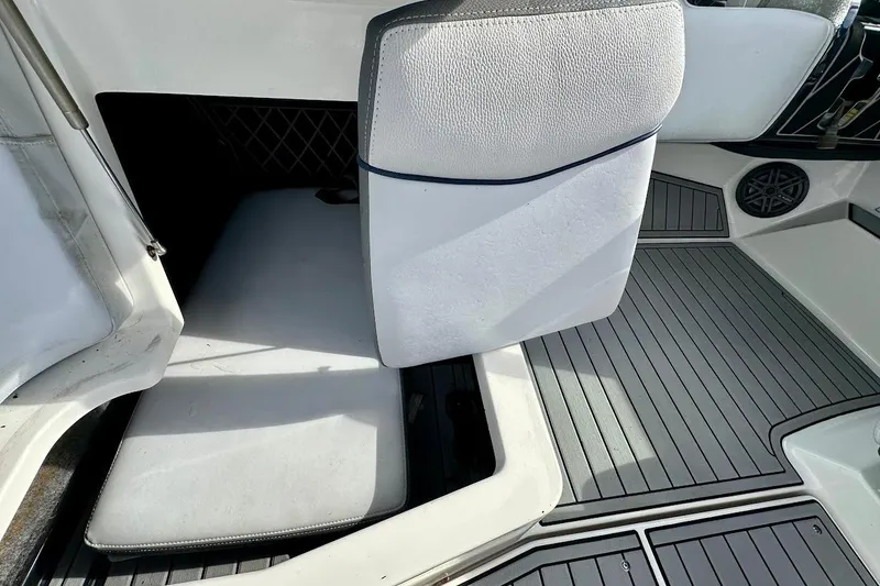 Slide: The Image of 2018 Nautique Super Air Nautique GS22 interior with open storage compartment and cushioned seating. - 32