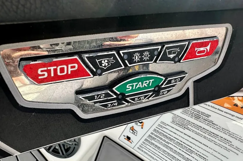 Slide: The Image of Control panel of 2018 Nautique Super Air Nautique GS22 boat with start and stop buttons. - 38