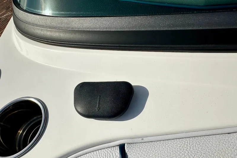 Slide: The Image of 2018 Nautique Super Air Nautique GS22 dashboard detail with cup holder and black cover. - 43