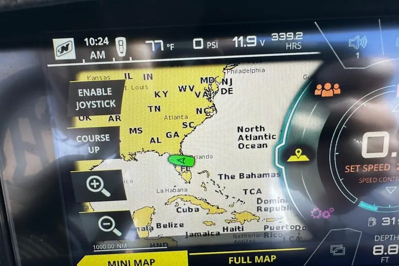 Slide: The Image of 2018 Nautique Super Air Nautique GS22 navigation display showing map and controls. - 49