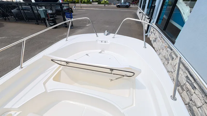 Slide: The Image of The image shows the bow of a Boston Whaler 170 Montauk boat with an open storage compartment. - 25