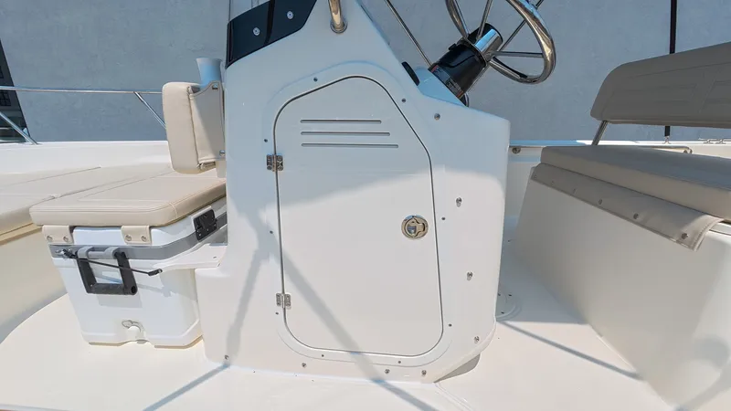 Slide: The Image of The image shows the cockpit of a Boston Whaler 170 Montauk with a helm station and seating. - 19