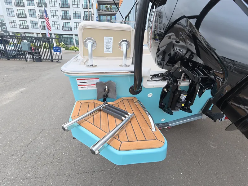 Slide: The Image of The image shows the stern of a Boston Whaler 170 Montauk with a swim platform and ladder. - 6