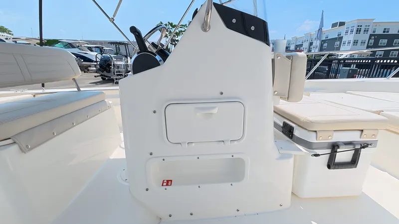 Slide: The Image of The image shows the cockpit of a 2027 Boston Whaler 170 Montauk with white seating and storage. - 17
