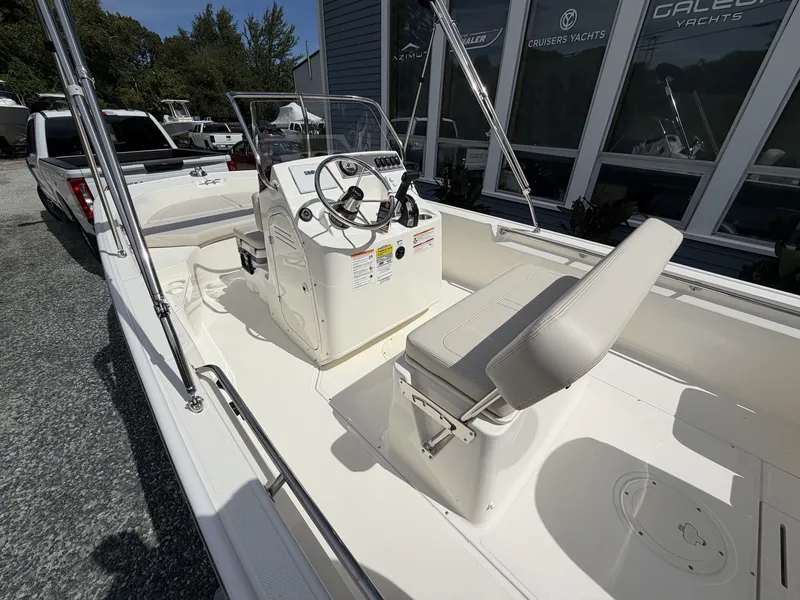 Slide: The Image of The image shows a 2027 Boston Whaler 170 Montauk boat with a helm and seating area. - 5