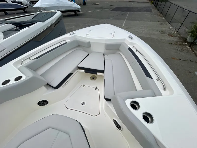 Slide: The Image of Boston Whaler 330 Outrage 2027: Spacious bow area with cushioned seating and cup holders. - 20