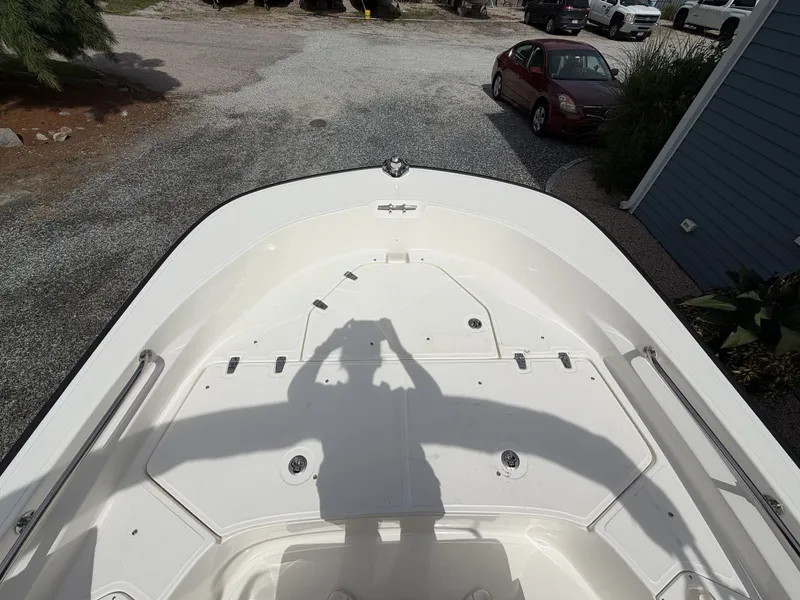 Slide: The Image of The image shows the deck of a 2027 Boston Whaler 190 Montauk, parked on a gravel lot. - 16