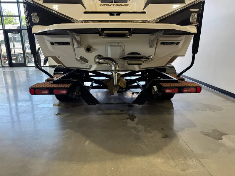 Slide: The Image of Rear view of a 2023 Nautique Super Air Nautique G23 boat in showroom. - 7