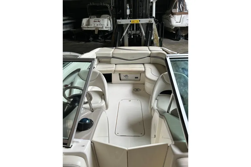 Slide: The Image of 2005 Maxum 2200 SR3 boat interior with seating and steering wheel in storage. - 10