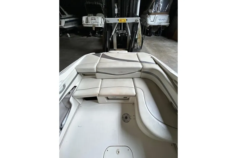 Slide: The Image of 2005 Maxum 2200 SR3 boat interior with white cushioned seating in storage facility. - 5
