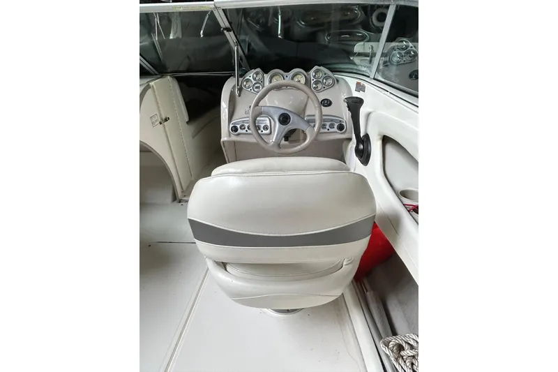 Slide: The Image of 2005 Maxum 2200 SR3 boat interior with steering wheel and dashboard controls. - 8