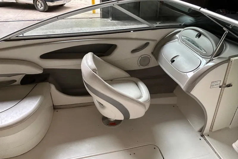 Slide: The Image of Interior of a 2005 Maxum 2200 SR3 boat, featuring seating and dashboard. - 9