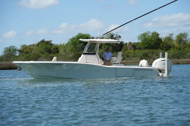 Slide: The Image of 2025 Grady-White 281 Coastal Explorer boat cruising on a serene lake. - 12