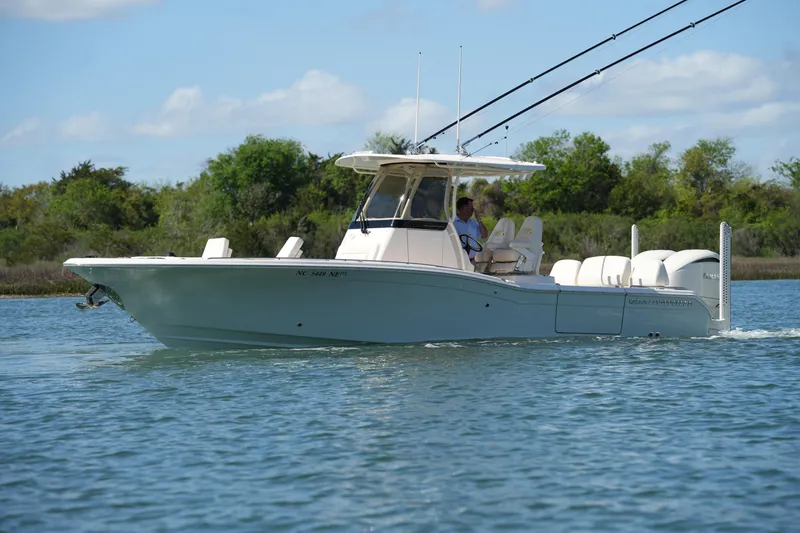 Slide: The Image of 2025 Grady-White 281 Coastal Explorer boat cruising on a serene waterway. - 13