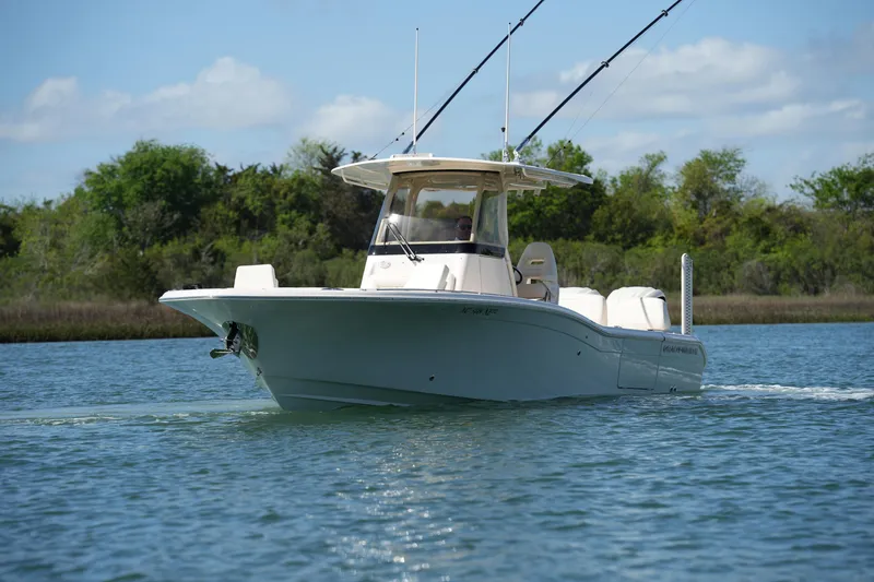 Slide: The Image of 2025 Grady-White 281 Coastal Explorer boat cruising on a serene waterway. - 14