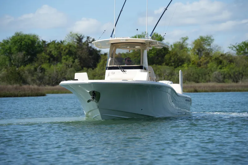Slide: The Image of 2025 Grady-White 281 Coastal Explorer boat cruising on a serene waterway. - 15