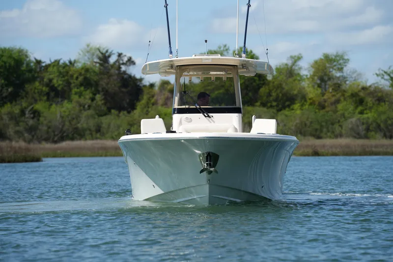 Slide: The Image of 2025 Grady-White 281 Coastal Explorer boat cruising on a serene waterway. - 16