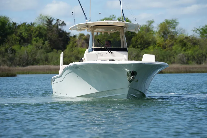 Slide: The Image of 2025 Grady-White 281 Coastal Explorer boat cruising on a serene waterway. - 17