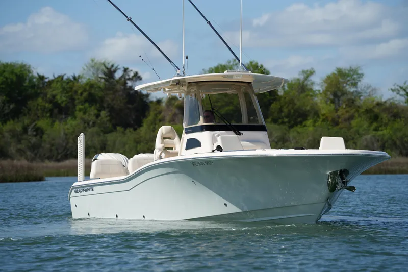 Slide: The Image of 2025 Grady-White 281 Coastal Explorer boat cruising on a serene lake. - 18