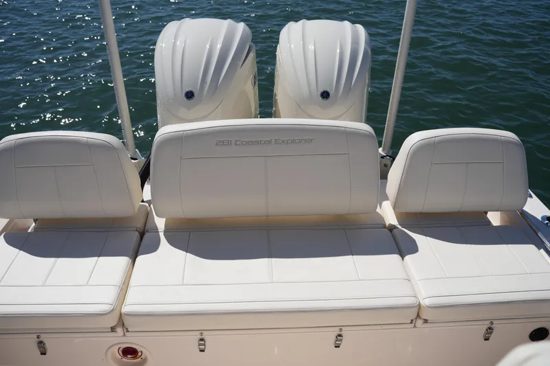 Slide: The Image of 2025 Grady-White 281 Coastal Explorer boat seats with dual engines on water. - 19