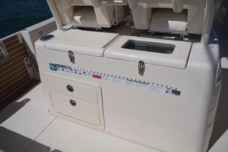 Slide: The Image of 2025 Grady-White 281 Coastal Explorer boat interior with storage compartments and seating. - 21