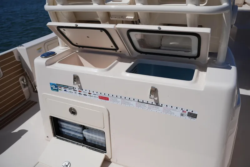 Slide: The Image of 2025 Grady-White 281 Coastal Explorer boat storage compartments and tackle boxes. - 22