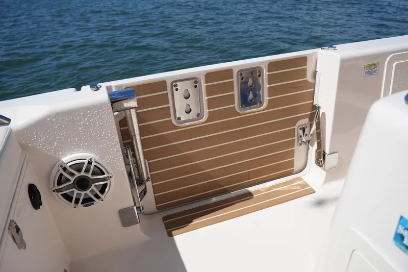 Slide: The Image of 2025 Grady-White 281 Coastal Explorer boat deck with speaker and water access. - 23