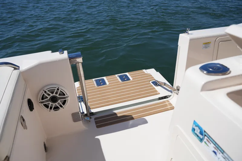 Slide: The Image of 2025 Grady-White 281 Coastal Explorer boat deck with swim platform and speaker. - 24