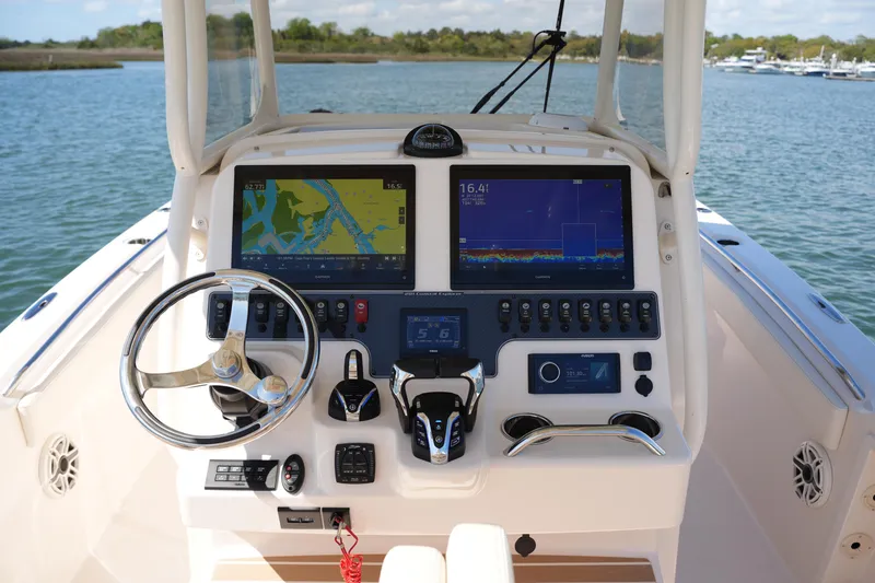 Slide: The Image of Helm of 2025 Grady-White 281 Coastal Explorer with advanced navigation displays and controls. - 27
