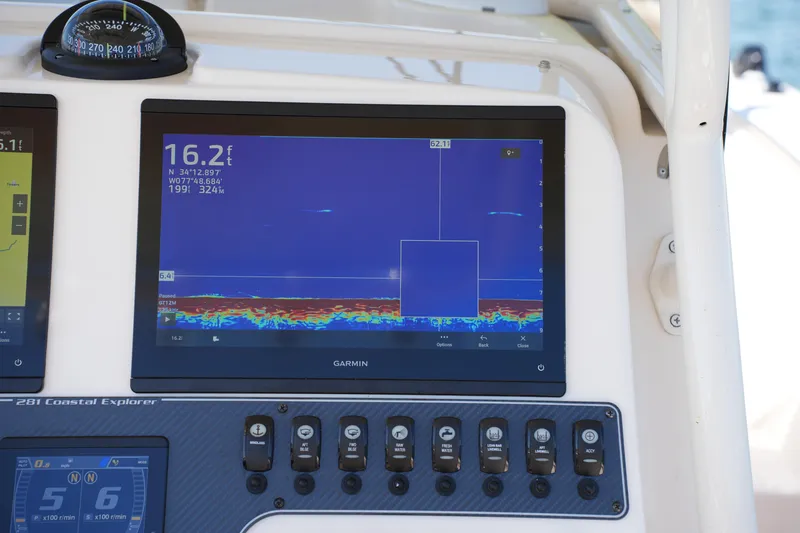 Slide: The Image of Dashboard of 2025 Grady-White 281 Coastal Explorer with Garmin navigation display. - 29