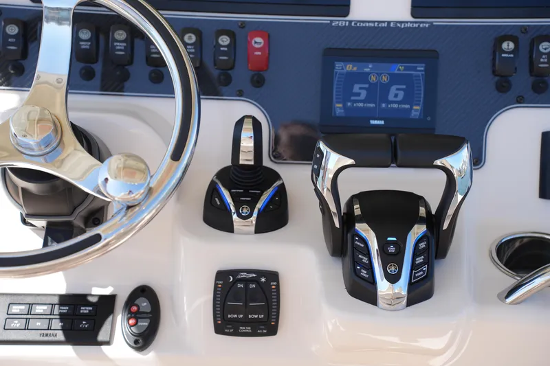 Slide: The Image of 2025 Grady-White 281 Coastal Explorer helm with advanced controls and digital display. - 31