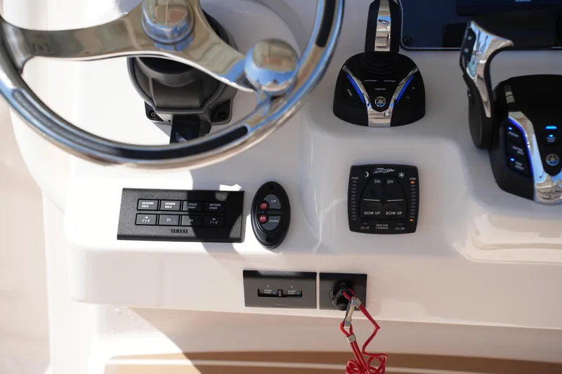 Slide: The Image of 2025 Grady-White 281 Coastal Explorer helm controls with steering wheel and Yamaha system. - 32