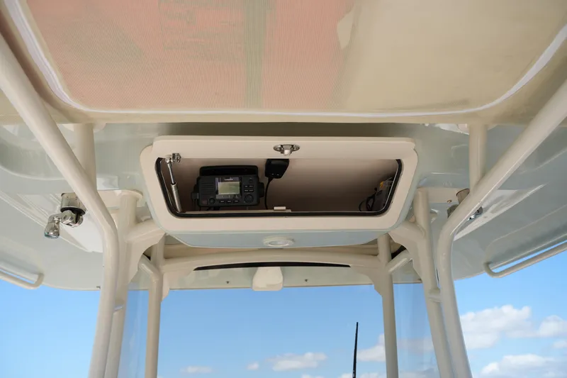 Slide: The Image of 2025 Grady-White 281 Coastal Explorer boat console with electronic equipment storage. - 34