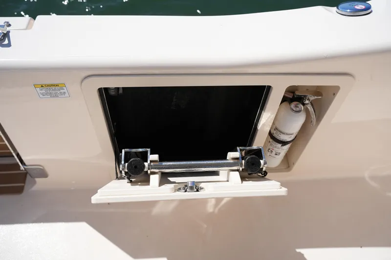 Slide: The Image of 2025 Grady-White 281 Coastal Explorer boat compartment with fire extinguisher. - 35