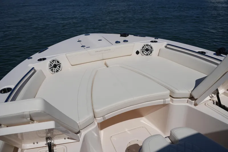 Slide: The Image of 2025 Grady-White 281 Coastal Explorer boat interior with cushioned seating and speakers. - 39