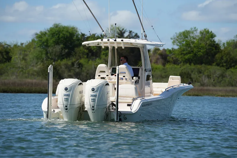 Slide: The Image of 2025 Grady-White 281 Coastal Explorer boat cruising on a serene waterway. - 4
