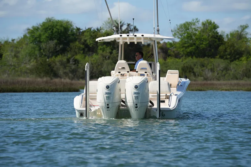 Slide: The Image of 2025 Grady-White 281 Coastal Explorer boat cruising on a serene lake. - 5