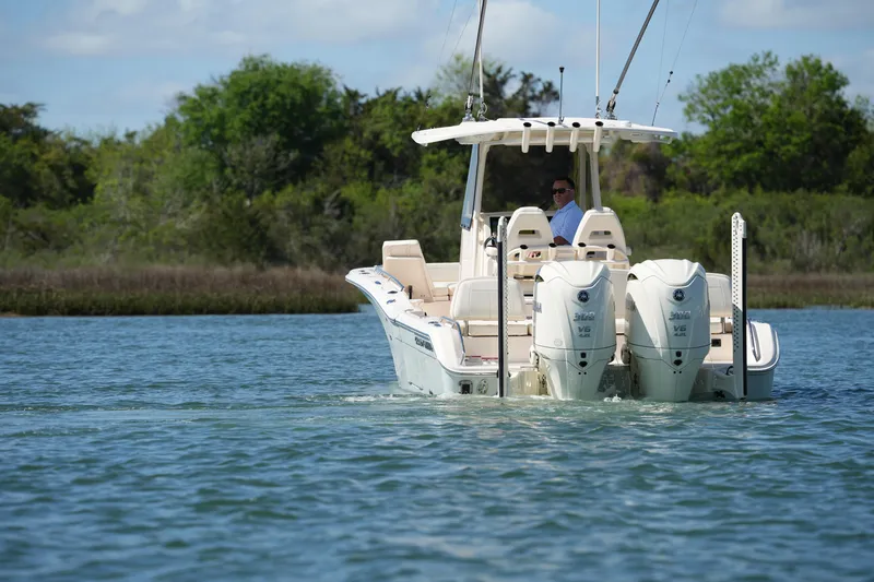 Slide: The Image of 2025 Grady-White 281 Coastal Explorer boat cruising on a serene lake. - 6
