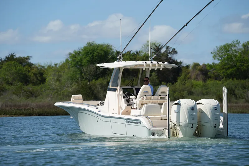 Slide: The Image of 2025 Grady-White 281 Coastal Explorer boat cruising on a serene waterway. - 7