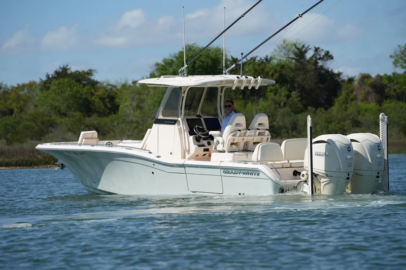 Slide: The Image of 2025 Grady-White 281 Coastal Explorer boat cruising on a serene waterway. - 8