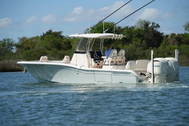 Slide: The Image of 2025 Grady-White 281 Coastal Explorer boat cruising on a serene waterway. - 9