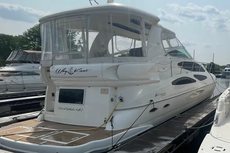 Slide: The Image of 2004 Cruisers Yachts 455 Express Motoryacht docked at marina, rear view. - 2