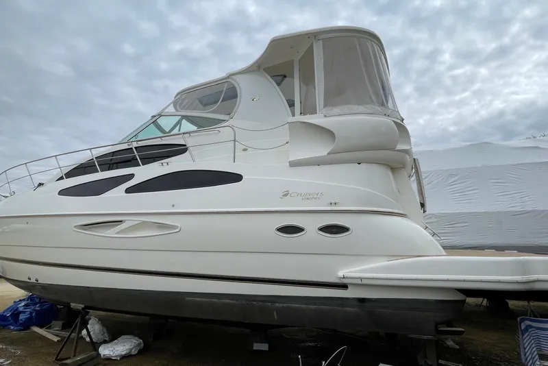 Slide: The Image of 2004 Cruisers Yachts 455 Express Motoryacht on dry dock under cloudy skies. - 23