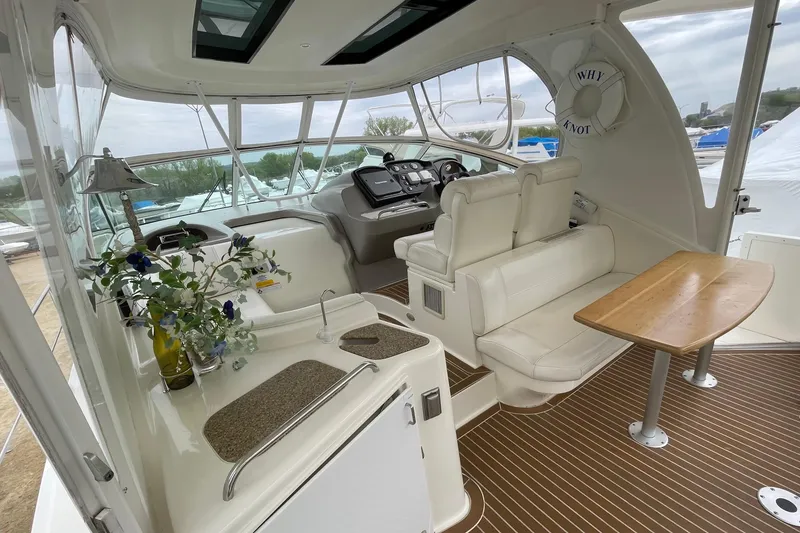 Slide: The Image of 2004 Cruisers Yachts 455 Express Motoryacht interior with helm, seating, and table. - 24