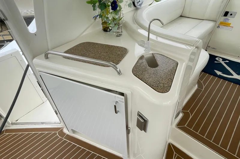 Slide: The Image of 2004 Cruisers Yachts 455 Express Motoryacht interior with sink and seating area. - 26